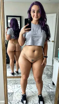 ((Plump scandinavian 20 year old girl, freckles, 5'2", purple hair, long hair, small/medium chest, 36c, pierced nipples, shaved pussy, straight hipsh pawg)), bulging pubic mound, plump pubis, ((sensual face), grey yoga shorts, tee shirts, taking a selfie, full body, in the bathroom mirror, mirror behind showing back side, covered pussy), view from behind