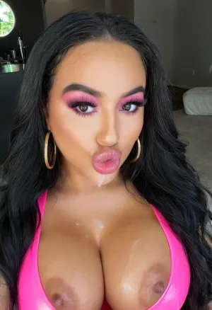 Selfie, headshot, 8k, intricate details. A gorgeous latina bimbo, looking at viewer, big dark eyes, big glossy pink lips, pouting, vibrant makeup, long thick eyeliner, big fake eyelashes, beautiful long dark hair, huge thick gold hoop earring, eyeliner, graphic eyeliner, thick eyelashes, dark skin, busty, cleavage, clothed in pink latex, bmbplora, cum facial, cum plastered, cum dripping down, <lora:406734_training_data:.5>, <lora:bimboxl_02:.6>, <lora:clothed_small:.5>, <lora:1122530_training_data:.6>, <lora:Pouting_SDXL:.6>