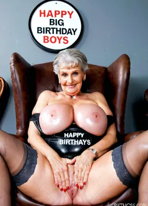 Very busty 60 years old gorgeous innocent grandmother, body exposed, huge siliconed big tits, perfect giant round boobs, amazing body, perfect grandmother's face, exhibitionist granny, "HAPPY BIRTHDAY BOYS" big sign, strapless shirt and pantyhoses, sitted on a leather armchair, kinky attitude, makeup, asshole exposed High detailed photo, high quality photo, close-up from below