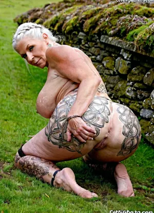 Very busty 60 years old stacked grandmother, huge siliconed big tits, perfect giant round boobs, amazing body, mature, scotland background, different situations, old celtic gilf, celtic patterned, body, colored body painting, stone, exposing herself, perfect face, huge round booty, on all fours High detailed photo, high quality photo, different angles, from behind