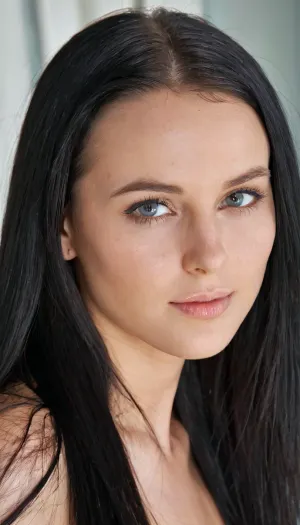 A very detailed and realistic portrait of a young woman with an intelligent yet attractive appearance. She has a delicate face, smooth fair skin and long straight black hair. Her expressive eyes are calm, giving her a sophisticated and diligent look.