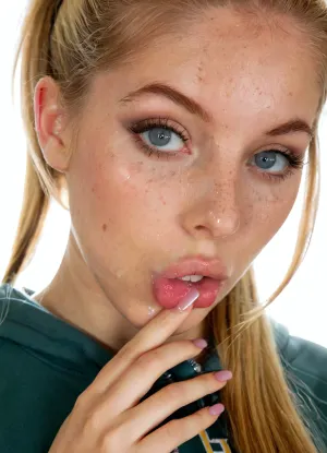 Breathtaking extremely junior Young girl, strawberry blonde hair, ((very long hair)), (luc14nn4, freckles, blue, eyes, soft, (warm ivory skin tone)), blue and grey colored mesmerizing eyes, perfect skinny body, medium perky fake breasts, perfect face, body sheen, glistening skin, macro shot, <lora:SDXL_BetterFaces-LoRA_v1:.8>, Black eyeliner. Heavy bronze eyeshadow. BREAK
Fully clothed in, (hot pink baggy college hoodie:1.2), . realistic eyes. biting her index fingernail, Sultry expression. Tousled, high ponytail. Eye contact, (sultry), confident. Petite, athletic, sweaty. Photorealistic. Viewer at eye level, close up. In a poorly lit, rundown basement of a derelict building. Close up, Canon RF 100mm F2.8L Macro IS USM, Kodak Portra 400 color film. Nostalgic, film-grain aesthetic., with an overall underexposure of 1-2 stops to accentuate the darkness and isolation of the environment. Close-up on face. Soft backlight.