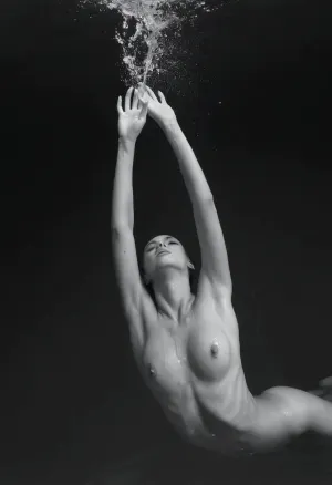 a black and white photo of a woman diving in the water, perfect face, perfect body, slender body, sensual, figuration libre, art photography, inspired by Eric Zener, big splash, fluidity, splashes, weightlessness, swimming across the universe