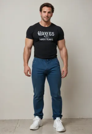 one white gay, 50 years old, middle brown hair, blue eyes, black t-shirt, (no prints), blue pants with big bulge, white sneakers, posing on white wall, muscular male, tanned skin, mature skin, older skin, hairy chest, hairy dick, big, muscle, large, hyper, huge, thick, limbs, thighs, arms, <lora:bodybuilder:.8>