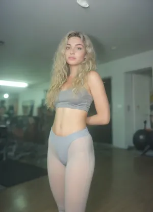 (casual photo flash), motion blur, (slightly overexposed:2), ((awkward angle:1.9)), ((composition is lacking)), (nighttime), (no ambient light), (single harsh flash from the camera), (overexposed flash highlights on subject), (sharp shadows behind and around her), (noise in all darker areas), (wet surfaces reflecting small highlights), (flat lighting due to direct flash), (cool white balance:1.3), (cyan-tinted shadows from digital camera sensor), (fluorescent-like artificial lighting tint), (background remains visible due to flash, but lacks blur or depth separation), (gym environment:2), (scene "Myspace"), (2000s), (90s digital aesthetic), (flat chested), (low quality photo), (old camera), (flash photo), (gritty), (swamp), (realistic environment), (analogic style), (film grain), (low contrast), (unfiltered), (jpeg artifacts), (unedited), (cellphone photography), (no ambient lighting), (lights off), (Polaroid flash camera), (cool indoor lighting), (direct flash photography), (overexposed flash), (strong shadows), (sharp shadows), (low contrast:2), (noise in dark areas), (shiny reflections on surfaces), (sharp background), (background in focus), (no background blur), (clear background details), (fluorescent lighting tint), (cyan-tinted shadows), (artificial lighting with cyan hue), (Scene-Queen), (optional), (Myspace), (picture), (bad quality), (old digital camera), (raw), (light leak), (low res), (low quality), (90s style), (80s), (analogic), (1990s), Ultra definition image, back view, ((focus on ass)), Social media babe in her room being sexy and presenting her booty, she's wearing leggings gs and a crop top, long blonde hair with long curls, puffy, nipples, polaroid, film, photography, longnightout, <lora:detailed_notrigger:.8>, <lora:MJ52:.8>, <lora:Nipples XL:.8>, <lora:Polaroidv2:2>, <lora:late night out_epoch_12:.7>