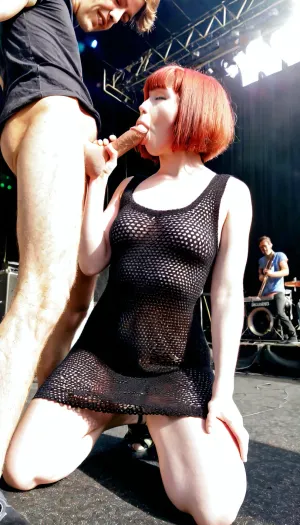Sexy redhaired groupie, (bobcut), wearing a black coarsely crocheted summer dress, kneeling, shaking her head, caresses her pussy and sucks the cock of the singer on stage during a sunny concert

Penetration, deep fuck, huge cock