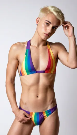 queer non-binary tomboy masculine androgynous boring looking female could also be a guy, skinny athletic, very short shaved blonde hair with undercut, piercings, ((full-body view)), high contrast, high quality details, ((armpits)), one-piece swimsuit, veins, masculine jaw, dominant, white plain background, small flat boobs, gay pride rainbow colors, cock-shaped bulge in panties