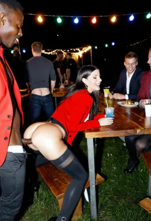 A slender woman spreading her legs on tabele and getting fucked by african men, woman has slim athletic figure, small breasts, small ass, long black hair, happy expression, men with varied builds, dressed in business casual attire, aroused and participating, intense vaginal penetrations, bodies intertwined in ecstasy, outdoor company party scene at night, crowded with many african men in the background watching or mingling, festive atmosphere with neon lights illuminating the area, tables with drinks, string lights overhead, amateurish style, like a candid smartphone photo, slightly grainy texture, realistic lighting with neon reflections on skin and clothing, high detail on fabrics, red blazer partially unbuttoned, black nylon shirt, black hips high leggings, high heels, low composition, side view, high resolution for clarity