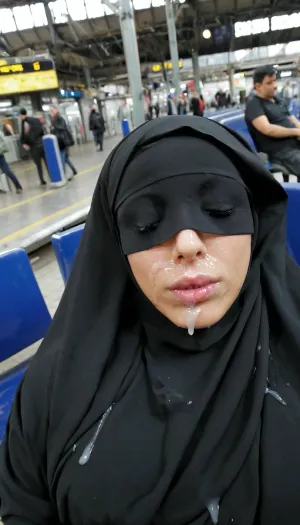 Girl sleeping in train station, wearing a burka, facial cumshot, cum on lips
