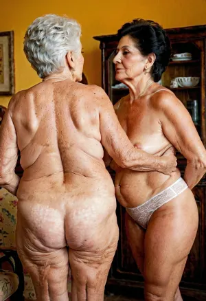 Granny, 78 age and 72 age old, black cut hair, hairy pussie, two very old back view, lesbians, old skin of the age.The nipples are slightly relaxed. they stand proudly completely naked and look at the viewer. One of them has only white, see-through, baggy panties, 1950s fashion, but see-through. Old ass and little hairy. Hairy pussies. Wrinkled tanned skin. Little chubby tummy. Grandmothers are short. Mexican type of woman. Height about 160 cm. Their hands touch their hairy pussies. Visible they asshole