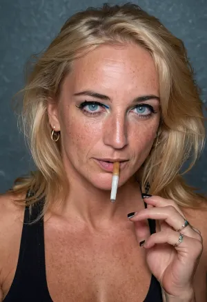 blonde woman, realistic photo of a Canadian prostitute 45 years old, white-trash ugly milf, crooked teeth, wearing a dirty from-fitting black tank top, braless, light blue eyes, smeared black mascara and eyeliner, (holding a cigarette between fingers:1.5), sharp focus, (8k uhd:.8), ultra-detailed, dimly lit, RAW Amateur Photo, photo-realistic, dyed-blonde hair, quality 4., Freckles, Natural, skin, <lora:Cosine_freck:.5>