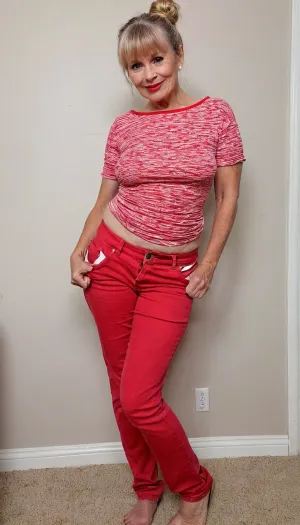 Full body view .76 years old granny wrinkled . Narrow waist . Tits saggy . White messy bun and bangs hair. Red jeans tight. . Happy .Pink lips. Red top. Full covered wear . .