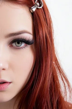 (unhinged predatory Kubrick stare, she's a serial killer and you're prey:20), (intense 27yo woman, heavy makeup, long false eyelashes), (vibrant flaming red hair, long luxurious hair, straightened hair, bobby-pin), (flawless pale skin), (large expressive eyes, pale hazel-green eyes), (surreal overexposed lighting, low contrast, blown-out white levels), (tight face close-up, focus on eyes)