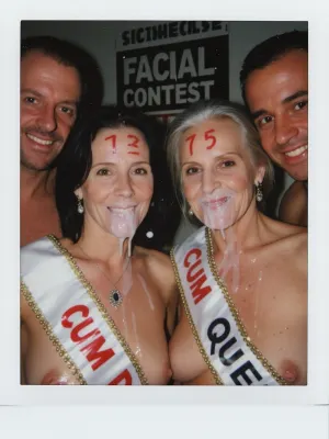 polaroid bad quality photo, camera flash, slightly dark background, wide view, far view, half body shot, (grandma), realistic two old french women 75yo side by side with age face wrinkles looking to cam, Two couples compete to see who is the cum queen, each husband behind her wife, constest different number wrote on the woman's forehead with red lipstick, There is a sign in the background with the text "FACIAL CONTEST", one of both has a sash across the chest with text wrote "CUM QUEEN", only one cum queen, the winner is the cum queen, (age face wrinkles:1.2), man smiles to cam too, short straight black hair, brown eyes, little natural tits, jewelry, pendant with jewel, ear rings, ruined makeup, after a bukkake party, their faces are completely covered in cum, an excessive amount of cum is on their faces, hair and in their mouths, cum is dripping down on their chests, her hair is messy, she is looking happy, she is smiling, her face is completely destroyed, in a domestic living room room