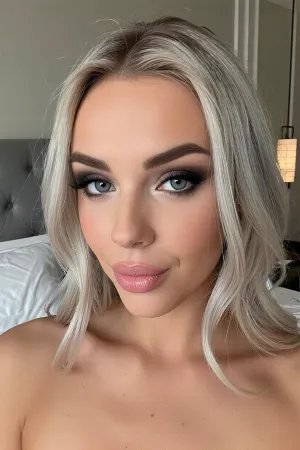 (sultry eastern european woman posing for a suggestive dating site selfie:4), (adorable girl-next-door with delicate features), (silver-blonde hair cut in an elegant chic style), (sultry smokey-look makeup), (light gray-blue eyes, large expressive eyes), (soft oval lips with kissable pillowy creases:2), cozy luxury bedroom with minimalist decor, (she shows a soft sensual smile as she seduces the viewer, one eyebrow slightly raised with an enticing and mischievous expression)