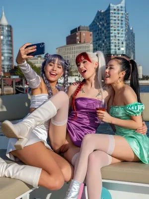 4 Asian African girls, Korean, Chinese, Japanese, doing a funny selfie shot with iPhone 17, they are wearing satin mini dresses with long boots and off shoulder top, they have long hair and braided pigtailed and ponytail hair, silver, lilac and red white green hair, flat chested, tattoos, luxury perfect makeup, they sitting together on a boat near the elbphilharmony, (one leg up:2), Harbour, outside, Hamburg, public, perfect architecture, sunshine, nice light, drinking cocktails, hug, smiling and talking, spread open legs with stockings, (crowd:1), (show gaping pussy:6)