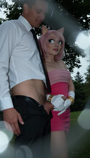 Create a candid snapshot in the style of a late-1990s/early-2000s disposable 35mm film camera, the depth of field is razor-thin, blurring the foreground into soft out of focus, tactile bokeh, nightmare atmosphere, dark and unsettling mood, lower angle view, Amy Rose from the Sonic the hedgehog, anthro, (Amy Rose have her white gloves with golden bracelets), Amy Rose small body, flat boobs, she is wearing her pink dress on top of her, (very detailed and accurate Amy Rose pink dress), male anon, male anon is wearing white buttoned down office shirt, black office trousers, (his black office trousers are lowered down so that his penis is visible, (perfectly shaved penis), Male anon is standing, Amy rose is standing behind male anon, Amy Rose is holding his penis with her hand from behind, (handjob), side view, (view from side), smiling, in a public park, masterpiece, professional image, very detailed image, 4K image), A low-resolution photo taken with an early mobile phone, the photo was taken in an amateur, candid manner, uncontrolled shadows. The background falls into complete darkness, Use a cheap consumer film camera aesthetic, 35–40mm equivalent lens, moderate depth of field, slight softness, imperfect autofocus, mild vignetting, uneven exposure, and natural perspective. No modern digital sharpness or smartphone processing.

Film look should include visible grain, slight color noise, halation around highlights, faded blacks, and imperfect white balance. Colors are cold from flash, with blue shadows, muted greens, and slightly faded tones. The image should resemble a scanned 35mm print.

Include authentic film imperfections, dust, tiny scratches, subtle motion blur, and exposure inconsistencies. Everything should feel organic, not added or artificial.

forground dissolving into soft bokeh, cool and muted tones, rust and pale grey palette, analogue film, heavy grain, scratches and film imperfections, Kodak Portra 400 underexposed, cool and melancholic, the woman sharp against the soft dissolved background, quietly devastated