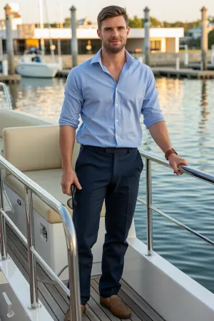 A photorealistic full body portrait of Caleb Mercer, a handsome twenty-six year old youth pastor from rural Tennessee, standing on the teak deck of a luxury yacht at an elegant marina.

Caleb is tall and lean with a naturally athletic build from hiking, camping, fishing, and construction work. He has short chestnut brown hair, warm hazel eyes, a neatly trimmed beard, a strong jaw, and a friendly but quietly authoritative expression.

He wears tailored navy linen trousers, a pale blue cotton shirt with the sleeves rolled neatly to his forearms, and clean brown leather boat shoes. His collar is open without a tie. He wears a simple leather watch and a plain silver wedding ring.

Caleb stands with one hand resting on the polished railing and the other holding sunglasses. His posture is relaxed and confident. His smile is warm, but there is a hint of possessiveness in his eyes.

Behind him are chrome railings, cream colored seating, calm blue water, and a marina glowing in warm late afternoon sunlight. Cinematic psychological drama, realistic skin texture, natural proportions, shallow depth of field, no text, no logos.
