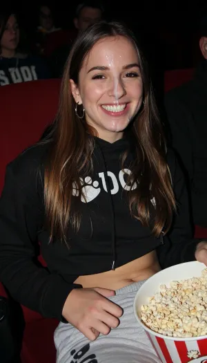 Night time. Smiling. Small waist. Long brown hair. Pawg. Hoodie. Sweat pants. Movie theatre. Bucket of popcorn. Sitting in seat. Hoop earrings., woman, . Face covered in cum.