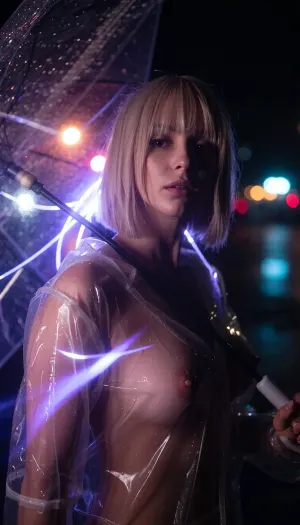 Close-up on her face, she faces the viewer, A highlight on her face, her face is visible in the darkness, she wears a clear rain coat, short blonde in a bob hair cut, breasts, holding an umbrella, rain rendered as glowing violet-purple light trails streaking downward off the umbrella edge, soft wet-glass texture with sharp raindrop streaks in the near foreground, dreamy out-of-focus bokeh lights in warm pink, orange and cool teal glowing softly behind, wet reflective ground, long exposure light painting style, high contrast black and purple palette with soft romantic bokeh glow, moody night atmosphere.