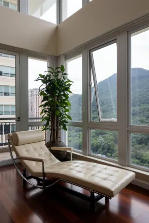 The scene is a high-rise apartment, skyscraper, large floor to ceiling windows, aged mahogany floors, a cream colored leather chaise lounge, a large Ceylon creeper, money plant, on the 12ft ceiling is a skylight, there is a balcony, far in the distance is a mountain that is deeply forested.