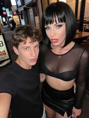 Selfie photo
In the street restaurant in japan, a young 18‑year‑old guy, a 45‑year‑old woman, Russian porn star, She has sexy, bold makeup, full lips, bob cut black hair with bangs, very busty, sheer black top, short black leather skirt