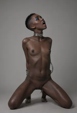 ((full body view, Solo, Tiny slender amazing beautiful 18 year old african black girl, black hair)), ((buzz cut:1.2)), (((black skin:1.8)), shaved pussy, nude, high heels), (((head up, expression of pleasure, open mouth))), (((back view))), ((kneeling upright, spread legs)), (((cheekbones, modern makeup, eyeliner, mascara, eyelashes, big blue eyeshadow))), (tiny tits, short body, small waist, ((hands behind her belly, handcuffs)), ((kneeling upright, showing pussy))), (((her back full of cane marks:1.5))), (((cane scars:1.4))), ((thick golden nipple rings)), makeup, eyeliner, eyelashes, <lora:flat_chested_v3.5:.8>, <lora:Modern_MakeUp_XL_v0_1:1>