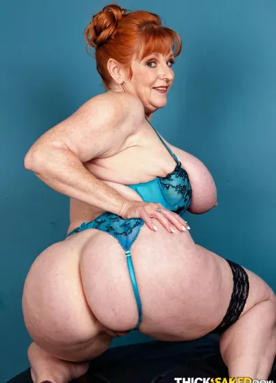 Thick and stacked old grandmother with extra large round siliconed boobs, real sensual grandmother having fun, at the studio, exhibitionist, 80's lingerie fashion model, different angles poses, suggestive poses, original design, ginger, makeup, asshole High detailed photo, high quality photo, cute face, full body