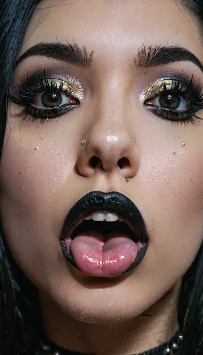 8k, highest detail, photo realistic, super close up, a goth girls face, septum piercing, upper lip piercing, long jet black hair, black lipstick, nose piercing, tongue piercing, black eyeliner, pale face, big anime eyes, mischievous look on her face, a cock resting on top of her head, the cock is oozing cum down her mischievous face, close_up_detailed_shot_of, <lora:close_up_detailed_shot_of1:1.4>