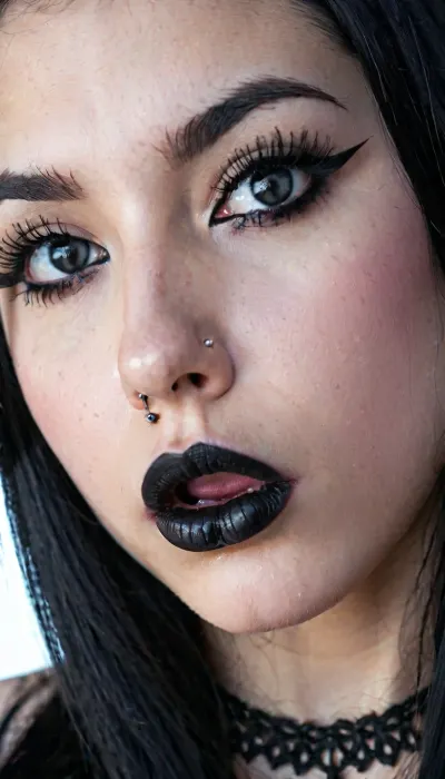 8k, highest detail, photo realistic, super close up, a goth girls face, septum piercing, upper lip piercing, long jet black hair, black lipstick, nose piercing, tongue piercing, black eyeliner, pale face, big anime eyes, mischievous look on her face, a cock resting on top of her head, the cock is oozing cum down her mischievous face, close_up_detailed_shot_of, <lora:close_up_detailed_shot_of1:1.4>