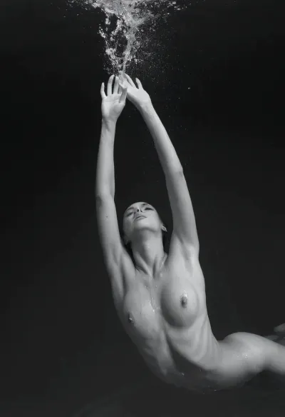 a black and white photo of a woman diving in the water, perfect face, perfect body, slender body, sensual, figuration libre, art photography, inspired by Eric Zener, big splash, fluidity, splashes, weightlessness, swimming across the universe