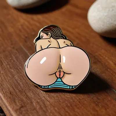 an enamel pin of a woman's ass, sitting on a wood table, flat color pin, asshole and pussy visible, spread ass cheeks, <lora:274698_training_data:.8>