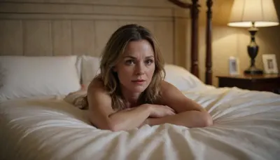 a 40 year old woman does it to herself. she lies in a neglected double bed