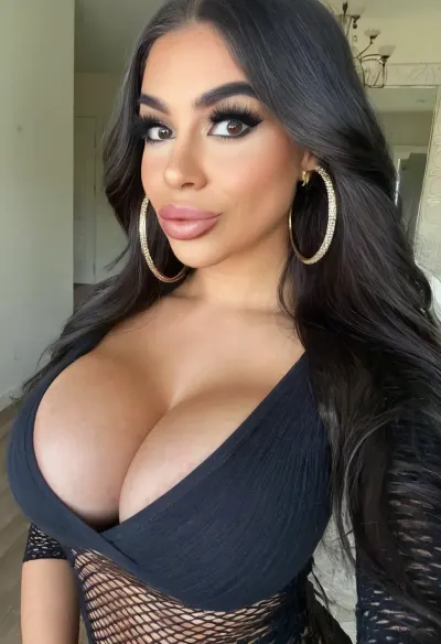 Selfie, headshot, 8k, intricate details. A gorgeous latina bimbo, looking at viewer, closed mouth, smirk, lipstick, makeup, beautiful long dark hair, huge thick gold hoop earring, graphic eyeliner, thick eyelashes, clothed in bimbo outfit, brown skin, busty, cleavage, bmbplora, <lora:406734_training_data:.5>, <lora:bimboxl_02:.6>, <lora:clothed_small:.5>, <lora:1122530_training_data:.6>