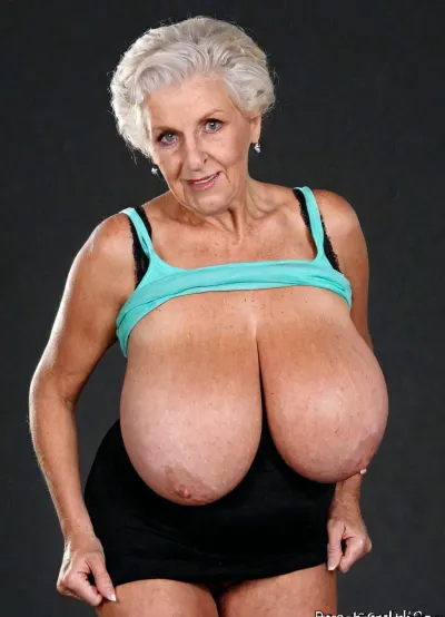 Innocent granny with oversized giant breasts poses, uninhibited, tight top, real old grandmother, exhibitionist, perfect body, funny accessories, perfect face High detailed photo, high quality photo, eyecontact, wide shot, photo studio