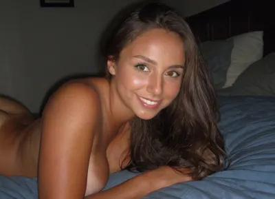 candid photo, comfident 21 year old college girlfriend, busty nude athletic body, long brunette hair, she is laying next to you in bed, dark bedroom, cute smile, ultimate realism, poor lighting, at night, dark, night, realistic detailed skin texture, focus on realistic face, stunning eyes, Sun-kissed skin
