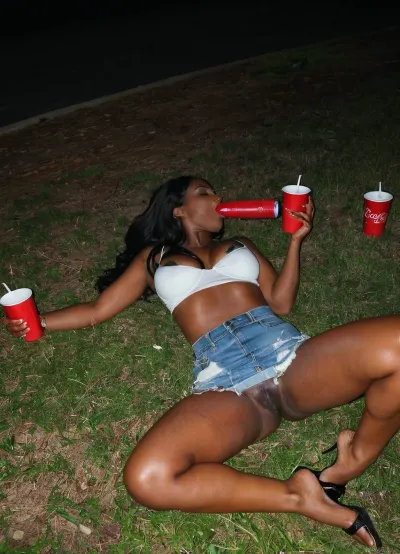 (A drunk hot black African-American 29-years-old female), african, has a nipslip at party, Laying down sleep on the ground, full body, ebony, flat long hair, red party cups are spilled around her, paparazzi shot, night time, denim skirt, white crop top, warm, light, style, puffy, dark, wide, <lora:warm light style v2:.5>, <lora:Nipples XL:.5>