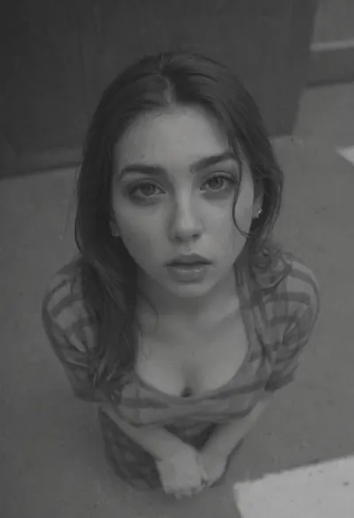 Moody black and white, monochrome, high contrast tones, natural harsh sunlight, closeup, from above, Decayed photo, vintage, film grain, film burn, extremely long hair, sidewalk, depth of field, blur, motion blur, fog, dust, haze, small body, chubby, youthful girl, holding her throat very tight, hand grasping throat, girl chocking, struggling, spit, salamis, gagging, eyes rolled into the back of her head, happy, optimism, makeup, perfect makeup, very tight checkered dress, youth, cute, very tight chest, long nipples, city street, stone buildings, street photography, very high contrast, fdec, eoriol, black, and, white, estevan, oriol, bw, grainy, chicano, culture, chola, lowrider, tattoo, 35mm, film, gangs, <lora:fdec:2>, <lora:Estevan_Oriol_Photography_Style-000005:2>