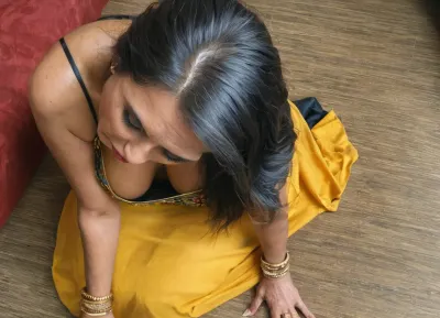 candid, voyeur, no nudity, (Realistic:1.4), traditional intricate sari, dupatta indian scarf, chiffon, lots of long fabric draped on her body, very very long black hair, sitting forward, 3/4 view, high angle, ((very closeup)), subtle downblouse, (traditional mature 60 yo. south indian mom:1.5), GILF, (dark brown skin:.9), (deep cleavage:.9), sitting in a luxury hotel lobby, (fully dressed in beautiful colorful saree:1), heavy eye liner, looking away, (averted gaze:1.2), chunky hips, pudgy belly, fat and ugly, heavy traditional gold indian jewelry, gold bangles, bridal, saree, downblouse, petticoat, <lora:bridal_saree:1.3>, <lora:RealDownblouseXL2:.8>, <lora:Desi_Fantasy:.8>, <lora:epoch-000112:.9>, <lora:clothed_small:1.3>