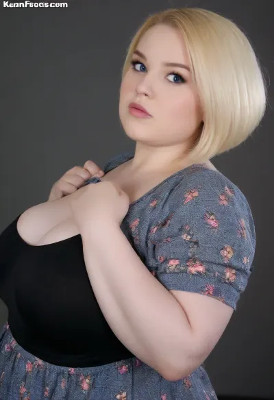 Profile, cute fat overweighted bbw, Short Blonde Bob haircut, chubby cheeks, blue eyes, soft chin, natural skin texture, soft shoulders, (fat massive bust), pretty blouse with detailed ornaments, doll like face, chubby waist, love Handles, oversized blouse, strong arms, long sleves. Gorgeous face, wide jawline, lustfully face expression, ratchet, amused, shot from side, (fully clothed), black background, model shot, <lora:clothed_small:.8>, <lora:DetailedEyes_V3:.8>