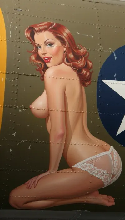 A vibrant and authentic vintage nose art painting stenciled onto the weathered olive-drab aluminum fuselage of a World War II B-17 bomber. The artwork depicts a stunning 20-year-old redhead pin-up woman with a youthful face and exquisite features, painted in a lush oil style with bold brushstrokes. She is posed kneeling in a side profile view, completely topless, with her bare breasts visible from the side. She wears only delicate retro lace lingerie bottoms. She has a playful, knowing expression with classic red lips and perfectly styled retro wavy hair. The painting is framed by metal rivets, panel lines, and weathered zinc-chromate scratches on the aircraft's metallic skin. Vibrant saturated colors, perfect vintage pin-up proportions, bold outlines suitable for military aircraft insignia, and high-contrast lighting that makes the artwork pop against the matte metallic background.