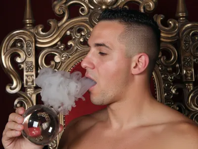 Hot man on the Throne, latino, buzzcut, smoking glass spehere with stem, and blowing out his mouth white clouds