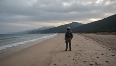 each color is solid and separated from the other by a thin line of a darker shade, bright yellow sand beach with the dunes which contours outlined by dark brown lines in the foreground flows into the soft shapes of the high mountains in the background, their contours outlined by dark grey lines, sky is dark blue, turning into purple in the distance, with red reflections over the mountains, it must be evening, aquamarine of the reservoir complete width of the field of view separates the beach from the mountains on the horizon, lonely small figure of a human in bright silver metal spacesuit with black face shield stands in foreground on the beach, lonely trail of footprints stretches across the sand from the human to the edge of the image, the human moves away from the viewer, visible from the back or from aside, laconism and graphics in the drawing of landscape evoke poster in constructivism style and enhance the dramatic effect, is enhanced by the light, which gives almost no shadows, the image is a symbol of loneliness and lostness in space