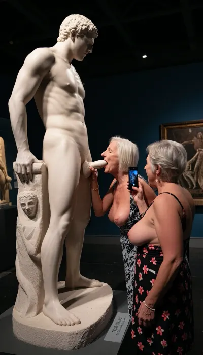 In a museum a side view of a normal man-sized statue in white marble of a male Greek god masturbating a very large erect penis., (The statue is on a plinth so his penis is at face level), Two busty grannies visiting the museum, one granny has her mouth open facing the the marble penis as if sucking on it, The other granny is taking a picture on her phone.
Both grannies are 60 yo chubby wearing low cut sundresses.
Sign on the statue base says “ PHALLUS, Greek God of Fornication”.
cinematic lighting, chiaroscuro