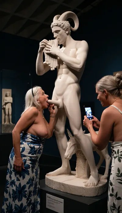 In a museum a side view of a normal man-sized statue in white marble of the God Pan playing the pan pipes and masturbating a very large erect penis., (The statue a horned man with goats legs and is on a plinth so his penis is at face level), Two busty grannies visiting the museum, one granny has her mouth open facing the the marble penis as if sucking on it, The other granny is taking a picture on her phone.
Both grannies are 60 yo chubby wearing low cut sundresses.
Sign on the statue base says “ PAN, Greek God of Fornication”.
cinematic lighting, chiaroscuro