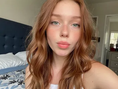 selfie photo. one woman in photo.

adorable 20 year old ginger with long wavy messy hair, freckles, huge green eyes, duck face, taking selfie.

Bedroom, daytime, amateur photo