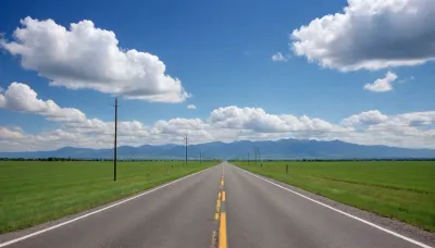 (in Michael Whelan art style), straight narrow old asphalt road stretches away into the distance, along the road are bright green fields and poles with wires on the right, a bright blue sky with white clouds, low mountains on the horizon far away, (saturated bright colors, high definition image, high contrast colors)