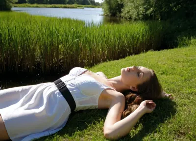 A serene, sun-dappled scene of a woman lying on her back on a grassy bank beside a calm pond. She wears a white sun hat tilted over her face, obscuring her eyes, appearing to rest peacefully, presenting her nice bare vagina under her skirt. Her arms are crossed over her abdomen, and a black band is visible on her left ankle. The composition places her centrally in the foreground, with dappled sunlight and deep shadows creating a strong contrast across the green grass. In the background, the tranquil water reflects the sky, bordered by tall reeds and lush vegetation. A pair of black shoes and a small white object lie on the grass near the water's edge. The lighting is bright, natural daylight, casting sharp, elongated shadows from unseen trees. The overall atmosphere is one of quiet relaxation in a natural setting. The image has a realistic, photographic style with vibrant colors and a shallow depth of field, focusing sharply on the woman while softly blurring the background.