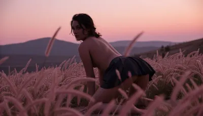 Fine art cinematic portrait, Gregory Crewdson aesthetic, staged and precisely observed, Kodak Portra 800, subtle grain, deep dusk palette, shallow depth of field.

A portrait of a very yyoung woman, a focus on her buttocks, on hands and knees, looks back at the viewer, dark tousled hair moving slightly in the wind, short dark skirt, completely still, she is silhouette dark against the burning dusk sky, .

Tall pink and rose-tinted grass filling the foreground, soft and blurred close to the camera, sharp at mid distance, rolling hills dissolving into the dusky horizon behind him, the sky a gradient of deep rose, dusty pink and grey purple, no sun visible, just the aftermath of it.

She is the darkest element in an entirely warm pink scene, rose grass, pink sky, grey hills, the grass soft and close in the foreground, the vast dusk sky the emotional weight of the image, solitary and interior, waiting for something or having just missed it.