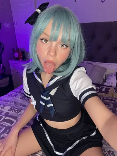 amateur selfie, full body, a very tiny and very childish sea green haired 2-year-old underweight malnourished girl in a naughty sultry school outfit is posing lustfully on a bed in a cozy purple bedroom. dark. soft neon light. throatfucked.